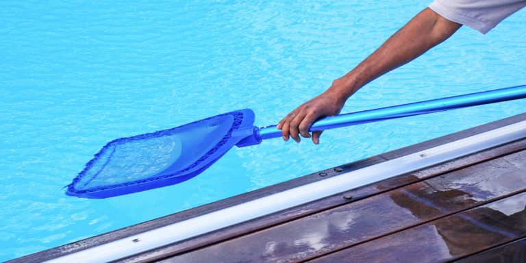Hotel staff african worker cleaning the pool